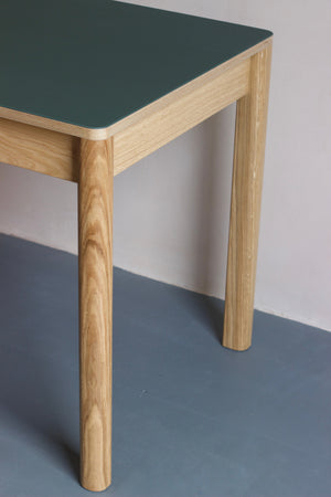 Forbo linoleum table is perfect as a contemporary dining table for family gatherings or as a modern work desk for home. It also features oak veneer frame with solid oak legs. Designed and made by Jon Grant London in Leyton, East London.