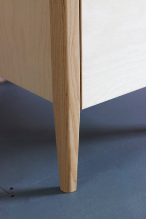 The Huxley birch plywood table featuring solid ash legs. Designed and made by Jon Grant London.
