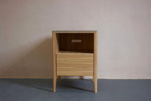 The Huxley bedside table in oak veneer plywood with Forbo linoleum top and solid oak legs. Designed and made by Jon Grant London in Leyton, East London.