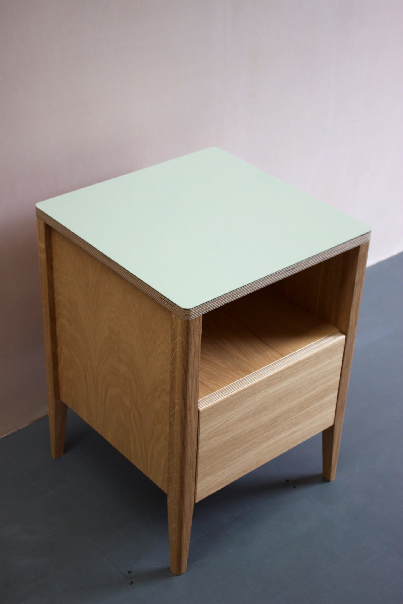 Handmade  bedside table, perfect for a modern home. It features Forbo linoleum top with oak veneered plywood and solid oak legs. Made by Jon Grant London in Leyton, East London.
