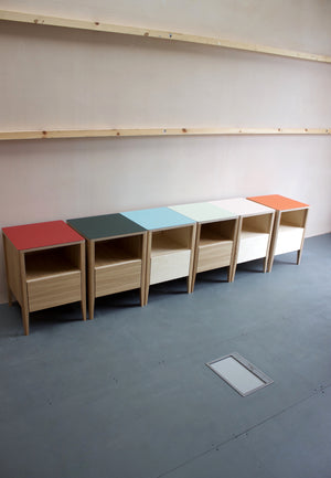 Huxley bedside tables in either oak or plywood carcasses, featuring solid oak or ash legs with Forbo linoleum plywood top. Designed and made by Jon Grant London.