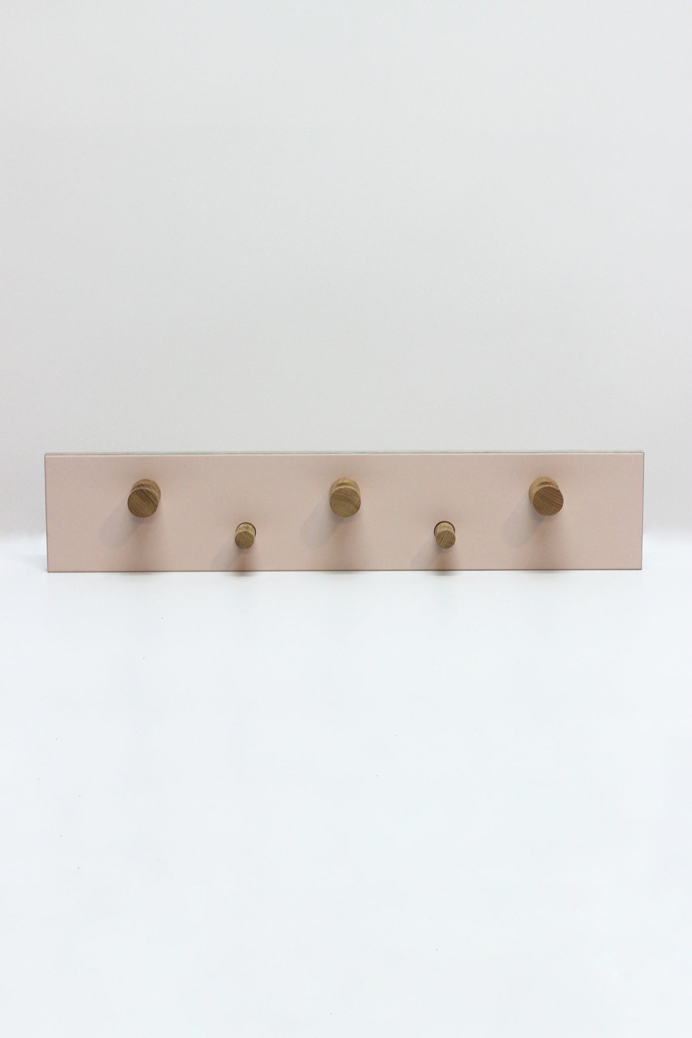 Colourful handmade solid oak coat hooks with Forbo linoleum top. Made by Jon Grant London in Leyton, East London.