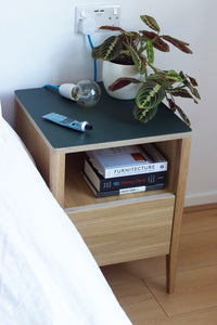 Handmade contemporary bedside table, perfect for a modern home. It features Forbo linoleum top with oak veneered plywood and solid oak legs. Designed and made by Jon Grant London in Leyton, East London.